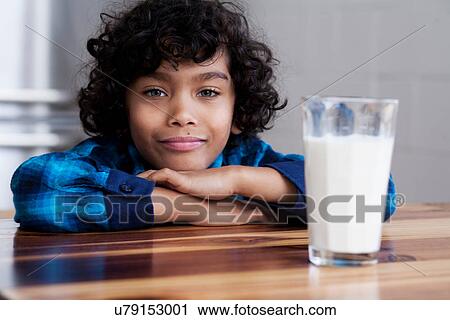 Stock Image - Portrait of boy with glass of milk. Fotosearch