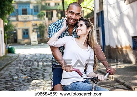 Portrait of couple on bicycle, Rio de Janeiro, Brazil View Large Photo Image Stock Photo - Portrait of couple on bicycle, Rio de Janeiro, Brazil. Fotosearch