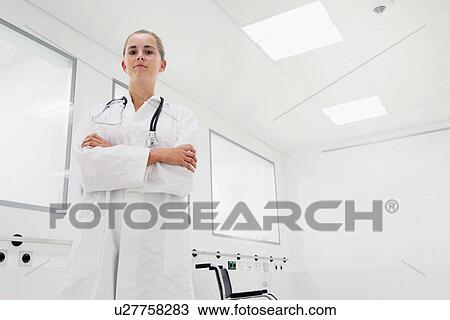 Stock Image - Portrait of female doctor in clinic. Fotosearch