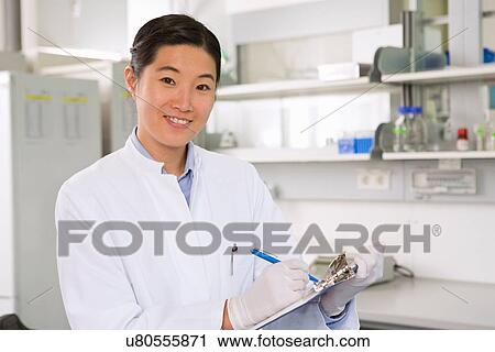 Portrait of female scientist working in laboratory with clipboard View Large Photo Image Stock Image - Portrait of female scientist working in laboratory with clipboard. Fotosearch