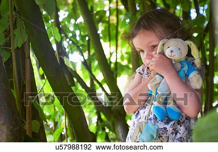 Portrait of female toddler with cuddly toy in woods View Large Photo Image Stock Image - Portrait of female toddler with cuddly toy in woods. Fotosearch