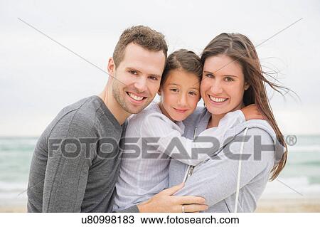 Portrait of girl and parents on beach View Large Photo Image Stock Image - Portrait of girl and parents on beach. Fotosearch