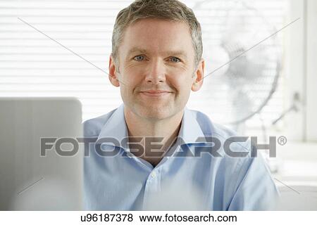 Stock Photo - Portrait of mature businessman looking at camera. Fotosearch