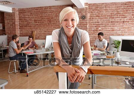Portrait of mid adult woman in creative office View Large Photo Image Stock Photo - Portrait of mid adult woman in creative office. Fotosearch