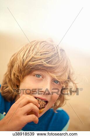 Portrait of teenage boy eating cake View Large Photo Image Stock Photo - Portrait of teenage boy eating cake. Fotosearch