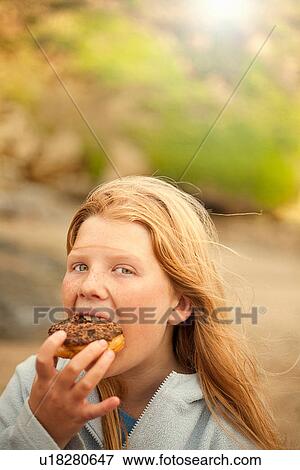 Portrait of teenage girl eating cake View Large Photo Image Stock Photo - Portrait of teenage girl eating cake. Fotosearch