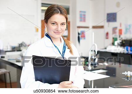 Picture - Portrait of teenage girl with clipboard. Fotosearch
