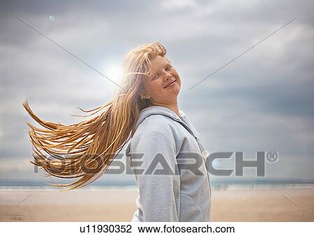 Portrait of teenage girl with long red hair on windy beach View Large Photo Image Stock Image - Portrait of teenage girl with long red hair on windy beach. Fotosearch