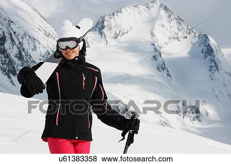 Stock Photo - Portrait of woman holding skis, Obergurgl, Austria. Fotosearch