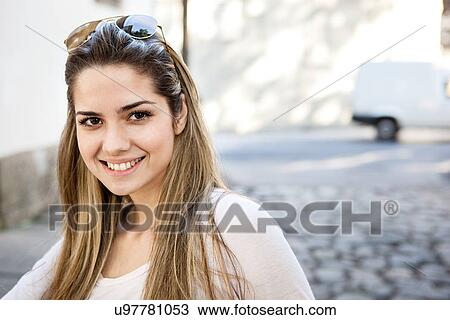 Stock Image - Portrait of woman with long blonde hair. Fotosearch