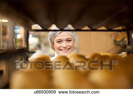 Portrait of young baker and tray of bread rolls View Large Photo Image Stock Photo - Portrait of young baker and tray of bread rolls. Fotosearch