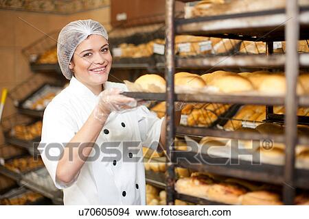 Portrait of young baker holding tray of bread rolls View Large Photo Image Picture - Portrait of young baker holding tray of bread rolls. Fotosearch