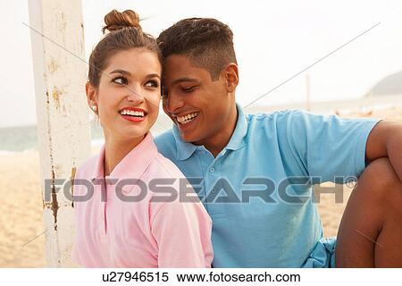 Stock Photography - Portrait of young couple on beach. Fotosearch