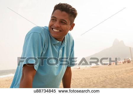 Stock Photography - Portrait of young man in Ipanema Beach, Rio de Janeiro, Brazil. Fotosearch