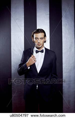 Portrait of young man wearing bow tie View Large Photo Image Stock Photo - Portrait of young man wearing bow tie. Fotosearch