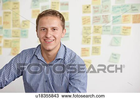 Portrait of young man with adhesive notes in background View Large Photo Image Stock Image - Portrait of young man with adhesive notes in background. Fotosearch
