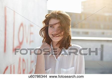 Portrait of young woman by wall with graffiti View Large Photo Image Picture - Portrait of young woman by wall with graffiti. Fotosearch