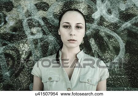Portrait of young woman in front of graffiti View Large Photo Image Picture - Portrait of young woman in front of graffiti. Fotosearch