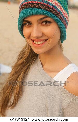 Portrait of young woman wearing knit hat View Large Photo Image Picture - Portrait of young woman wearing knit hat. Fotosearch