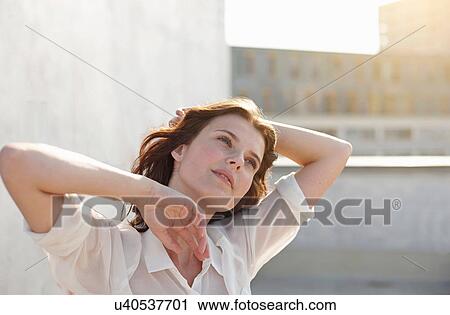 Portrait of young woman with hand in hair View Large Photo Image Stock Image - Portrait of young woman with hand in hair. Fotosearch