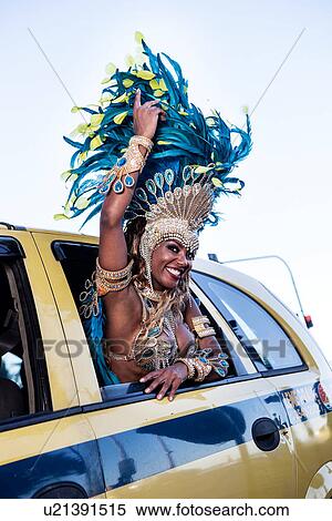 Stock Photography - Samba dancer in a taxi cab, Ipanema Beach, Rio De Janeiro, Brazil. Fotosearch