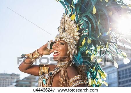 Stock Photo - Samba dancer using cellphone, Ipanema Beach, Rio De Janeiro, Brazil. Fotosearch