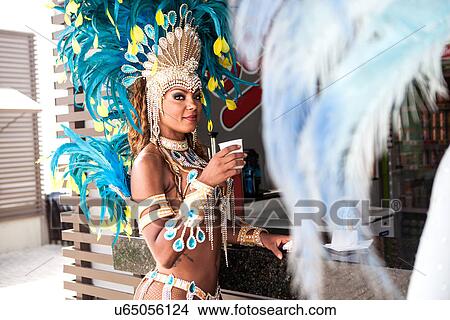 Picture - Samba dancer with refreshment, Rio De Janeiro, Brazil. Fotosearch