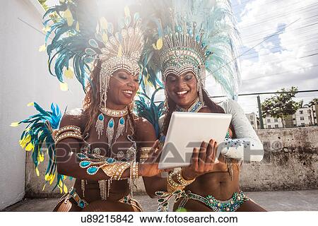 Samba dancers in costume, using digital tablet, Rio De Janeiro, Brazil View Large Photo Image Stock Image - Samba dancers in costume, using digital tablet, Rio De Janeiro, Brazil. Fotosearch