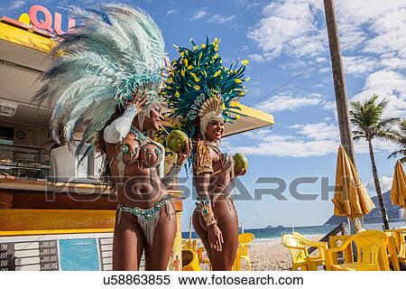 Stock Photography - Samba dancers in costume with coconut drinks, Ipanema Beach, Rio De Janeiro, Brazil. Fotosearch