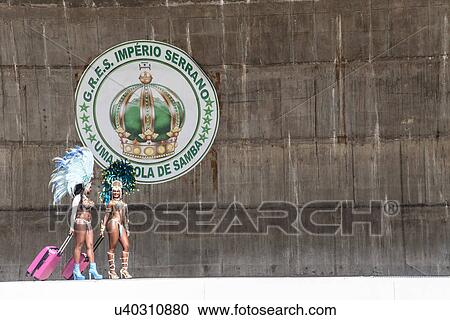 Samba dancers wheeling suitcases by sign on wall, Rio De Janeiro, Brazil View Large Photo Image Stock Image - Samba dancers wheeling suitcases by sign on wall, Rio De Janeiro, Brazil. Fotosearch