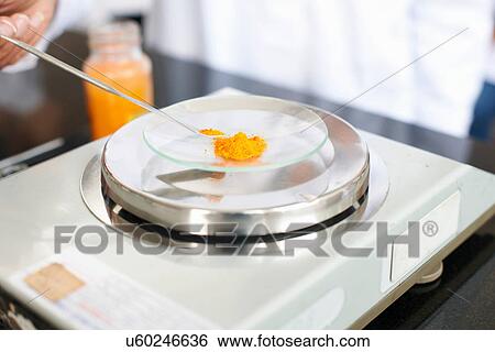 Stock Photograph - Science student weighing powder. Fotosearch