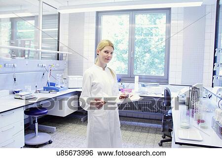 Scientist with tray looking at camera View Large Photo Image Stock Photograph - Scientist with tray looking at camera. Fotosearch