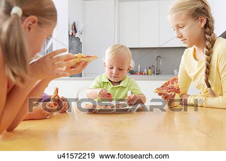 Siblings sharing pizza View Large Photo Image Stock Photo - Siblings sharing pizza. Fotosearch