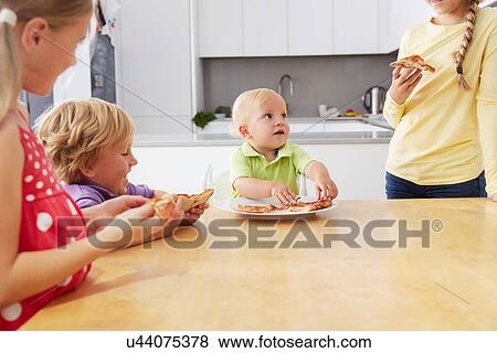 Siblings sharing pizza View Large Photo Image Stock Photo - Siblings sharing pizza. Fotosearch