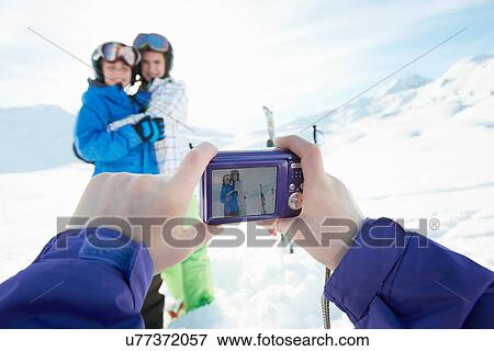 Sister photographing siblings in snow, Les Arcs, Haute-Savoie, France View Large Photo Image Stock Photo - Sister photographing siblings in snow, Les Arcs, Haute-Savoie, France. Fotosearch