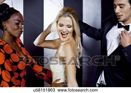 Small group of young people dancing in nightclub View Large Photo Image Stock Image - Small group of young people dancing in nightclub. Fotosearch