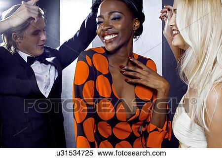 Stock Photography - Small group of young people dancing in club. Fotosearch