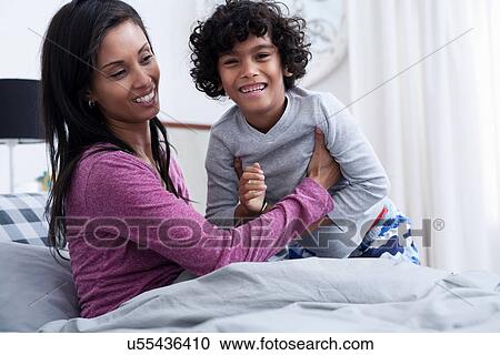 Son and mother in bed, smiling View Large Photo Image Stock Image - Son and mother in bed, smiling. Fotosearch