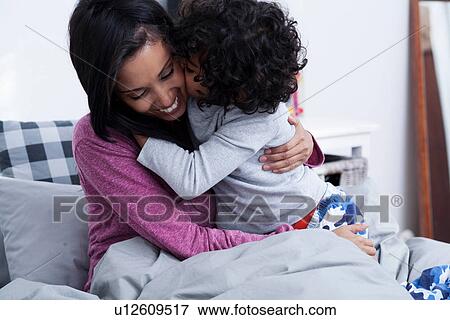 Son and mother in bed, smiling View Large Photo Image Stock Photo - Son and mother in bed, smiling. Fotosearch