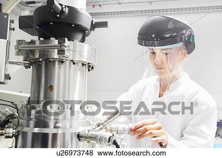 Stock Photo - Technician working in optical laboratory. Fotosearch