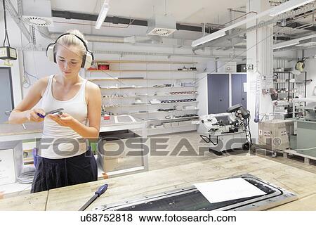 Stock Photo - Technician working in optical laboratory. Fotosearch