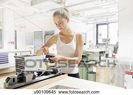 Stock Photography - Technician working in optical laboratory. Fotosearch