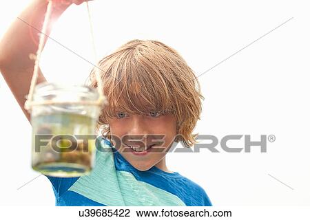 Teenage boy holding jar View Large Photo Image Stock Image - Teenage boy holding jar. Fotosearch
