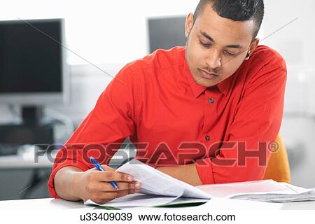 Stock Photo - Teenage boy studying. Fotosearch