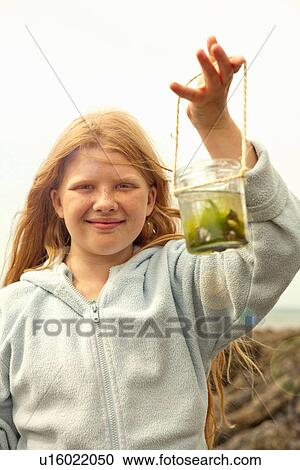Teenage girl holding jar View Large Photo Image Stock Image - Teenage girl holding jar. Fotosearch