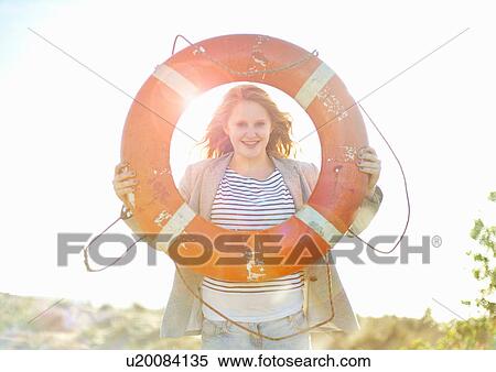 Stock Photography - Teenage girl holding life ring. Fotosearch