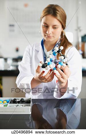 Picture - Teenage girl holding molecular model. Fotosearch