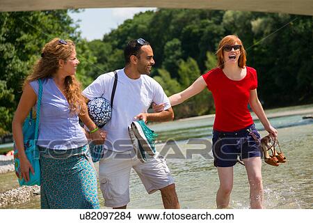 Three friends near Isar River, Munich, Germany View Large Photo Image Picture - Three friends near Isar River, Munich, Germany. Fotosearch