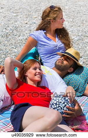 Three friends relaxing on holiday View Large Photo Image Stock Photo - Three friends relaxing on holiday. Fotosearch