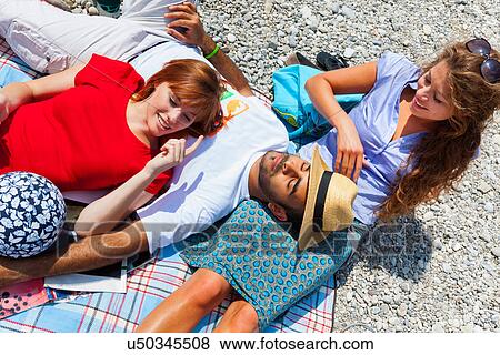 Stock Photo - Three friends relaxing on vacation. Fotosearch